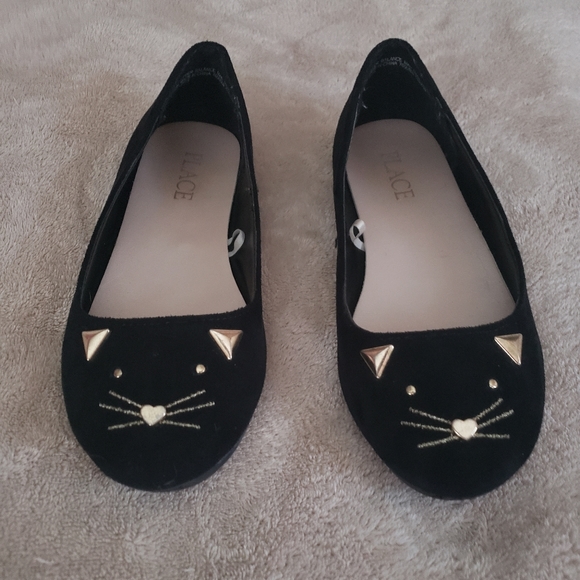 black dress shoes with gold accents